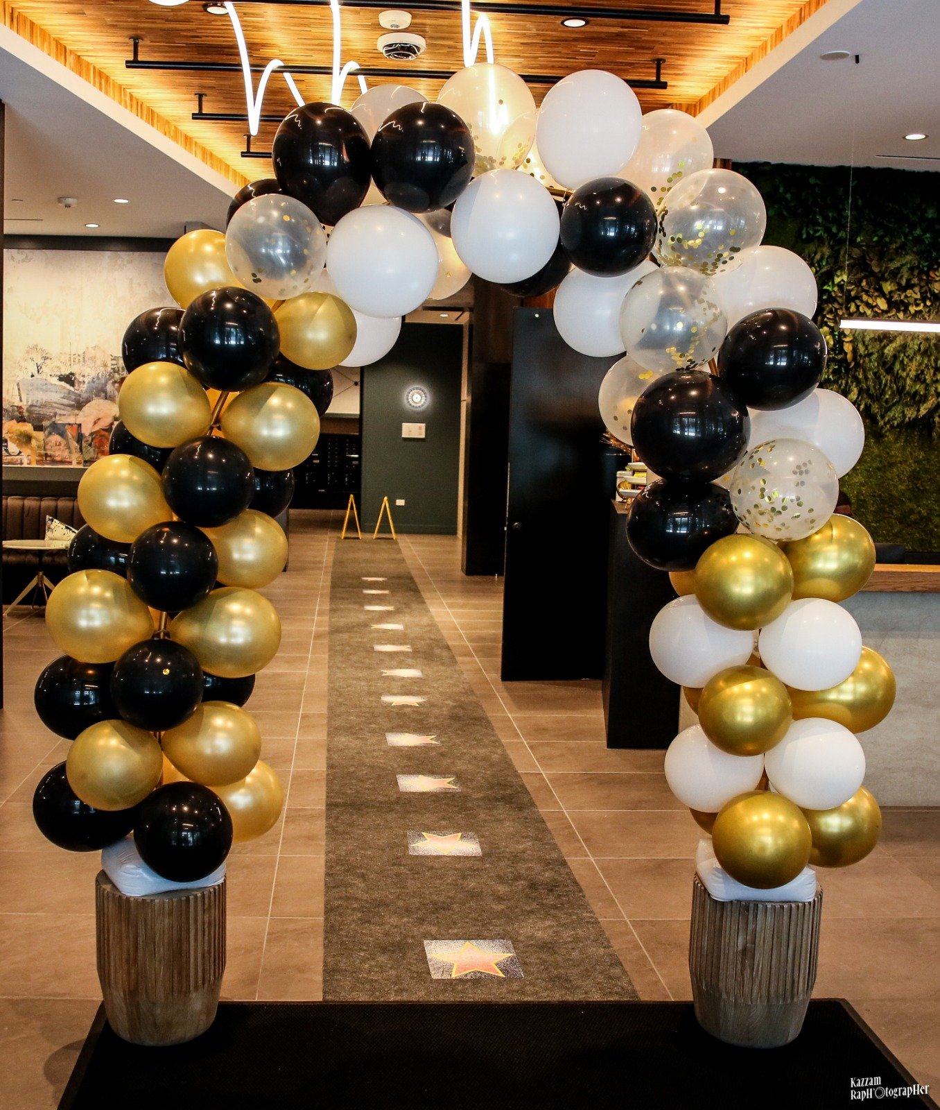 Black, white, and gold balloon arch created for a SYSY Services event