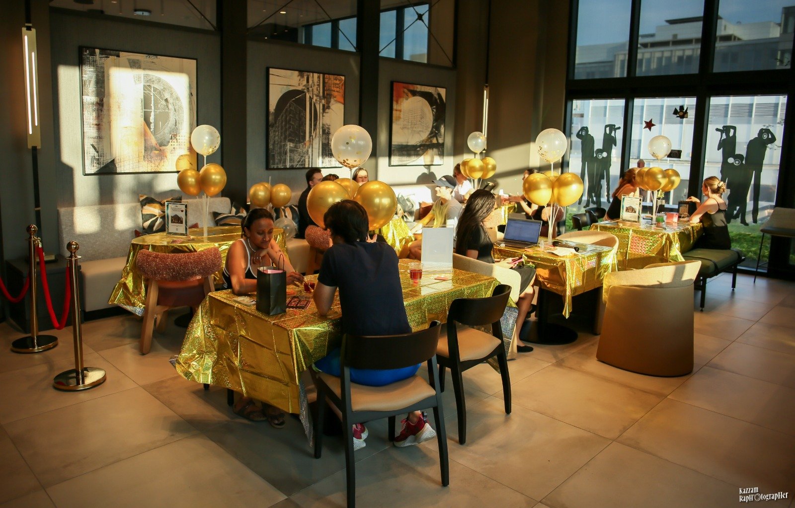 Guests enjoying a gold-themed SYSY Services event