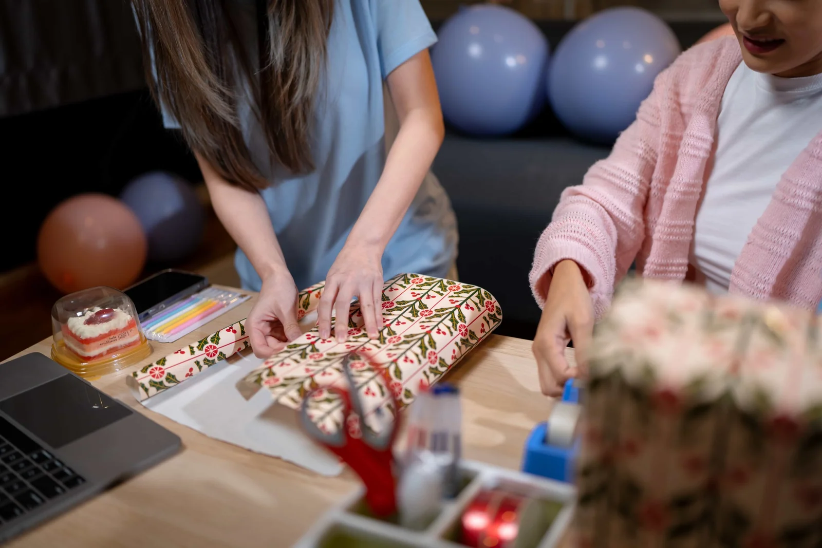 Hands preparing a carefully wrapped gift